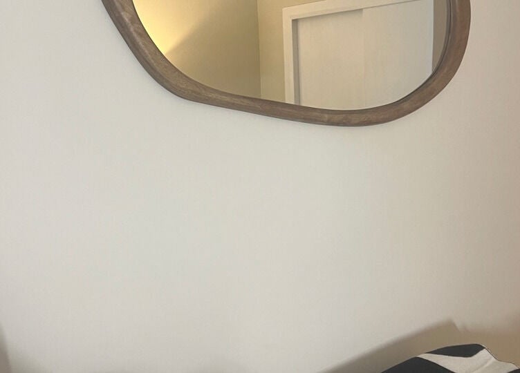 Elegant mirror reflection at Babylon, Ramsey, England, GB showcases refined interior design.