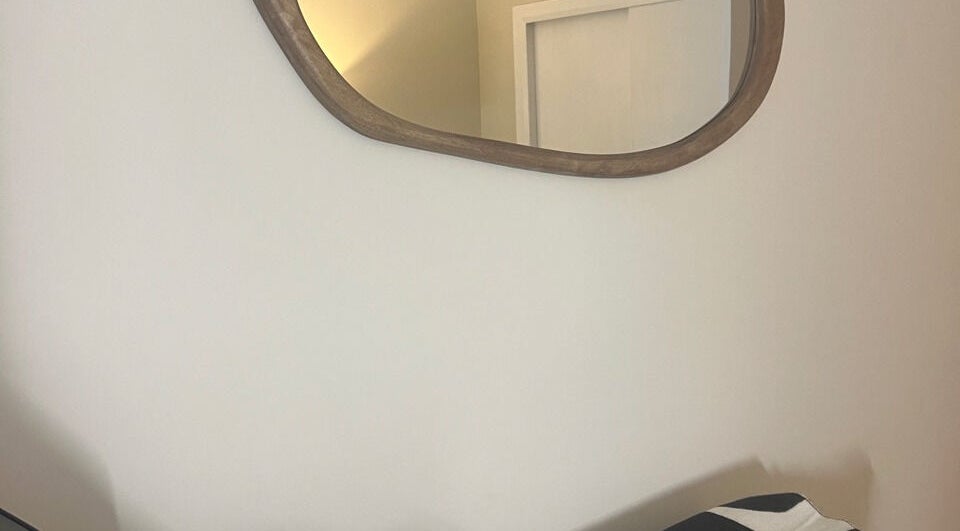 Elegant mirror reflection at Babylon, Ramsey, England, GB showcases refined interior design.