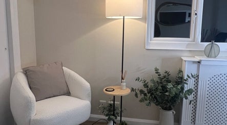 Inviting corner with a plush chair and elegant decor at Babylon, Ramsey, England, GB.