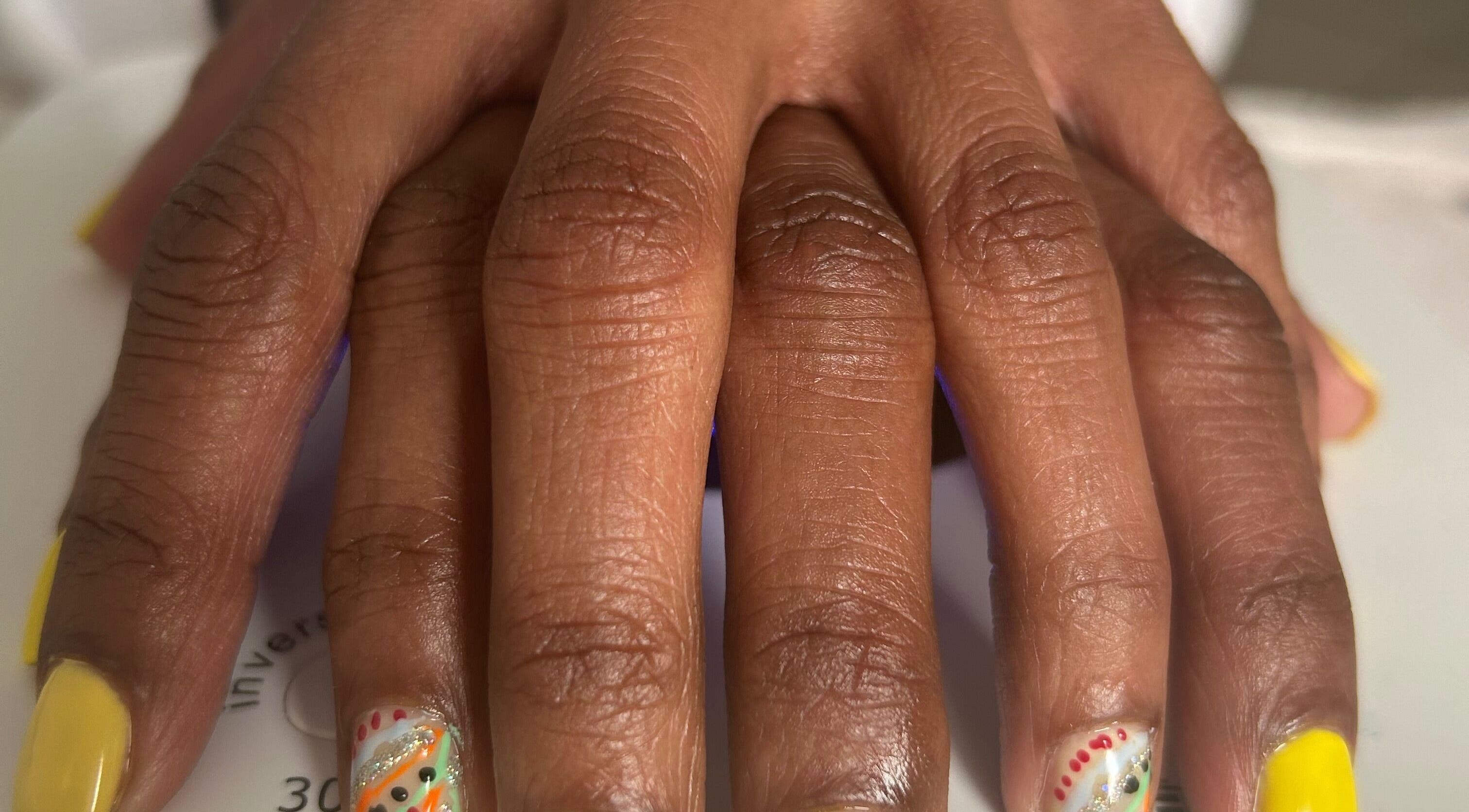 Bright nail art at La Rosé Des Beauté Nails, Randburg, Gauteng, ZA. Glitter, yellow polish, detailed designs.