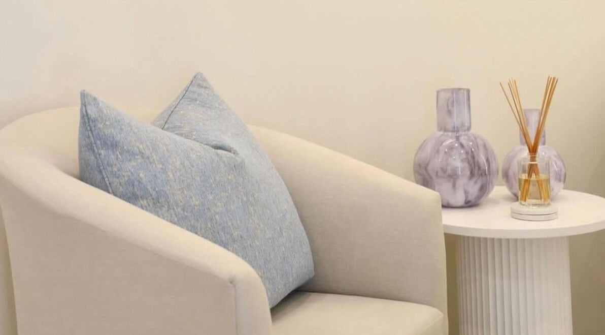 Elegant seating with blue pillow at The Beauty Scientist, Hurstville, New South Wales, AU enhances relaxation.