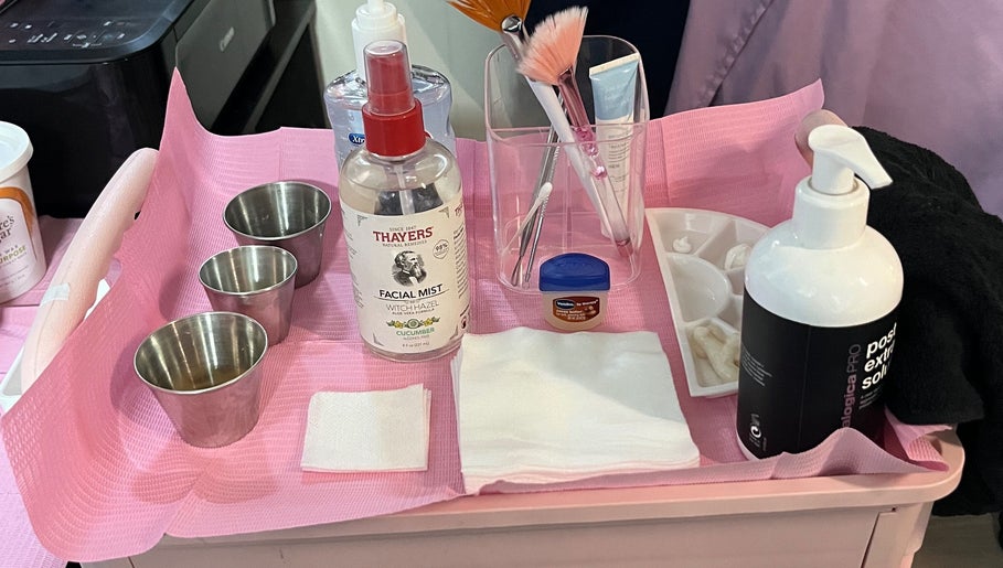 Skincare products and tools on a pink tray at Hope Esthetics, West Covina, California, US.