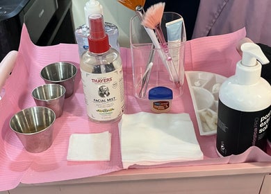 Skincare products and tools on a pink tray at Hope Esthetics, West Covina, California, US.