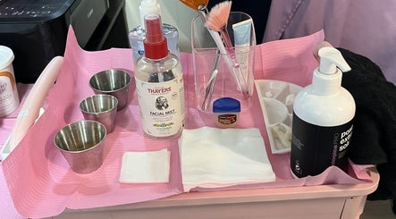 Skincare products and tools on a pink tray at Hope Esthetics, West Covina, California, US.