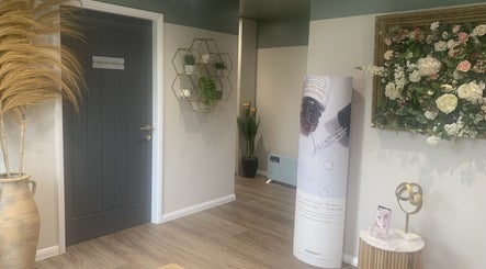 Elegant entrance to therapy room at Repton Revive, Repton, England, GB with floral decor and modern accents.