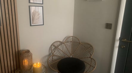 Warm and inviting corner at Repton Revive in Repton, England, GB with candlelight and wicker decor.