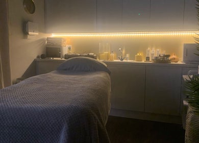 Relaxing massage room at Repton Revive, Repton, England, GB with dim lighting and a comfy massage table.