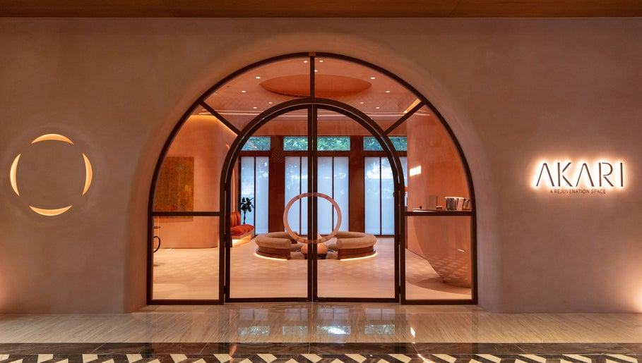 Stylish entrance of AKARI in District, دبي, AE showcasing modern design and warm lighting.
