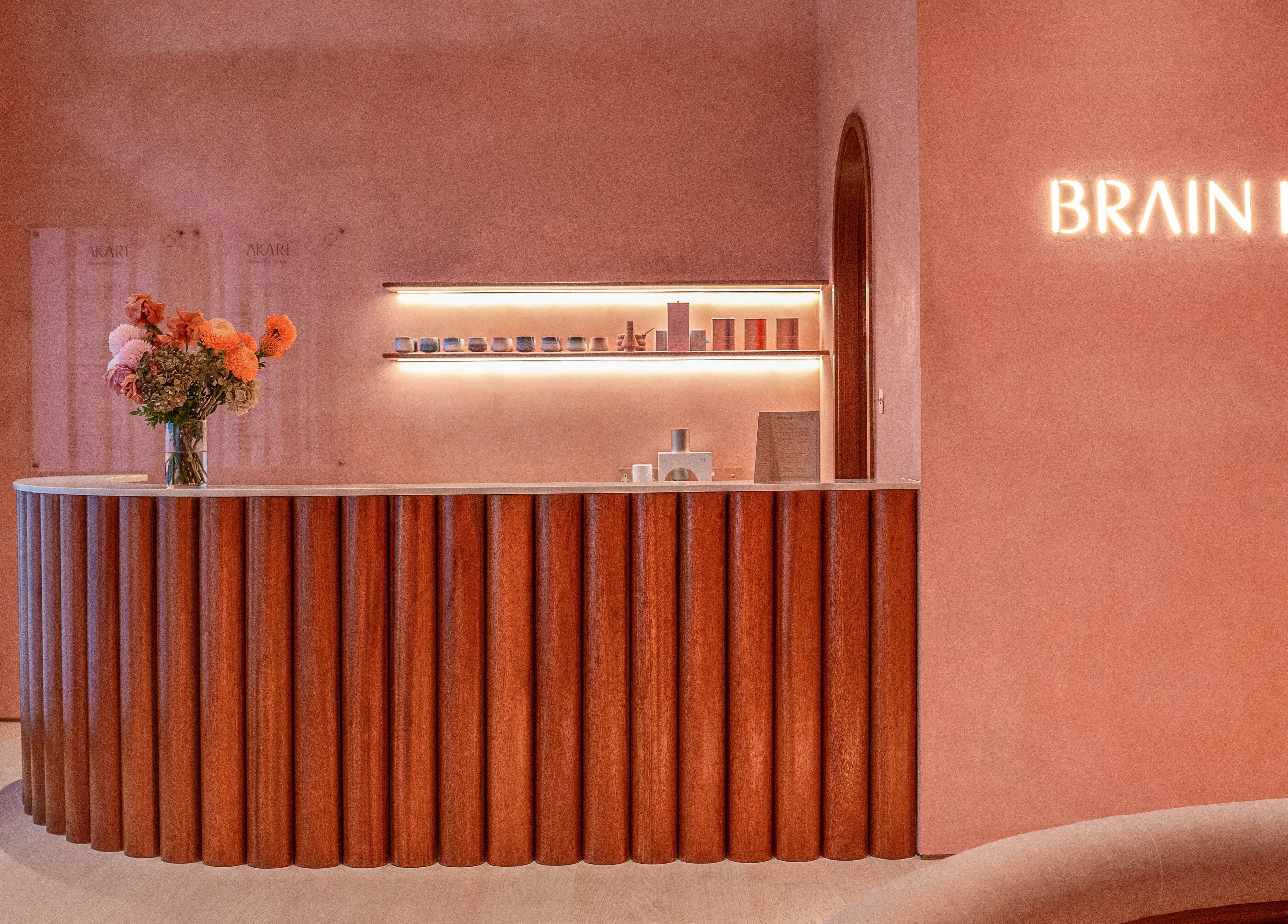 AKARI reception area in District, دبي, AE with modern decor and warm lighting.