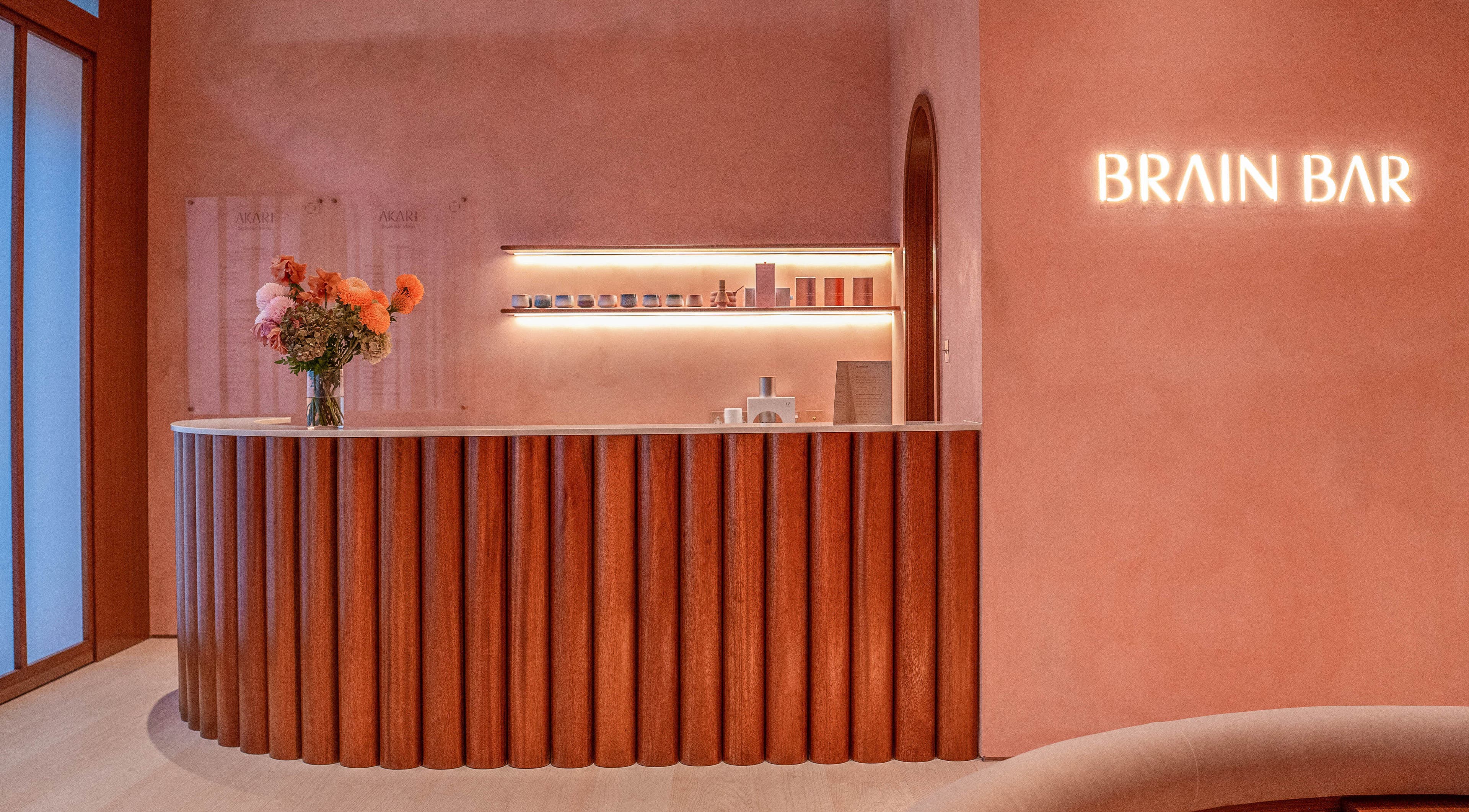 AKARI reception area in District, دبي, AE with modern decor and warm lighting.