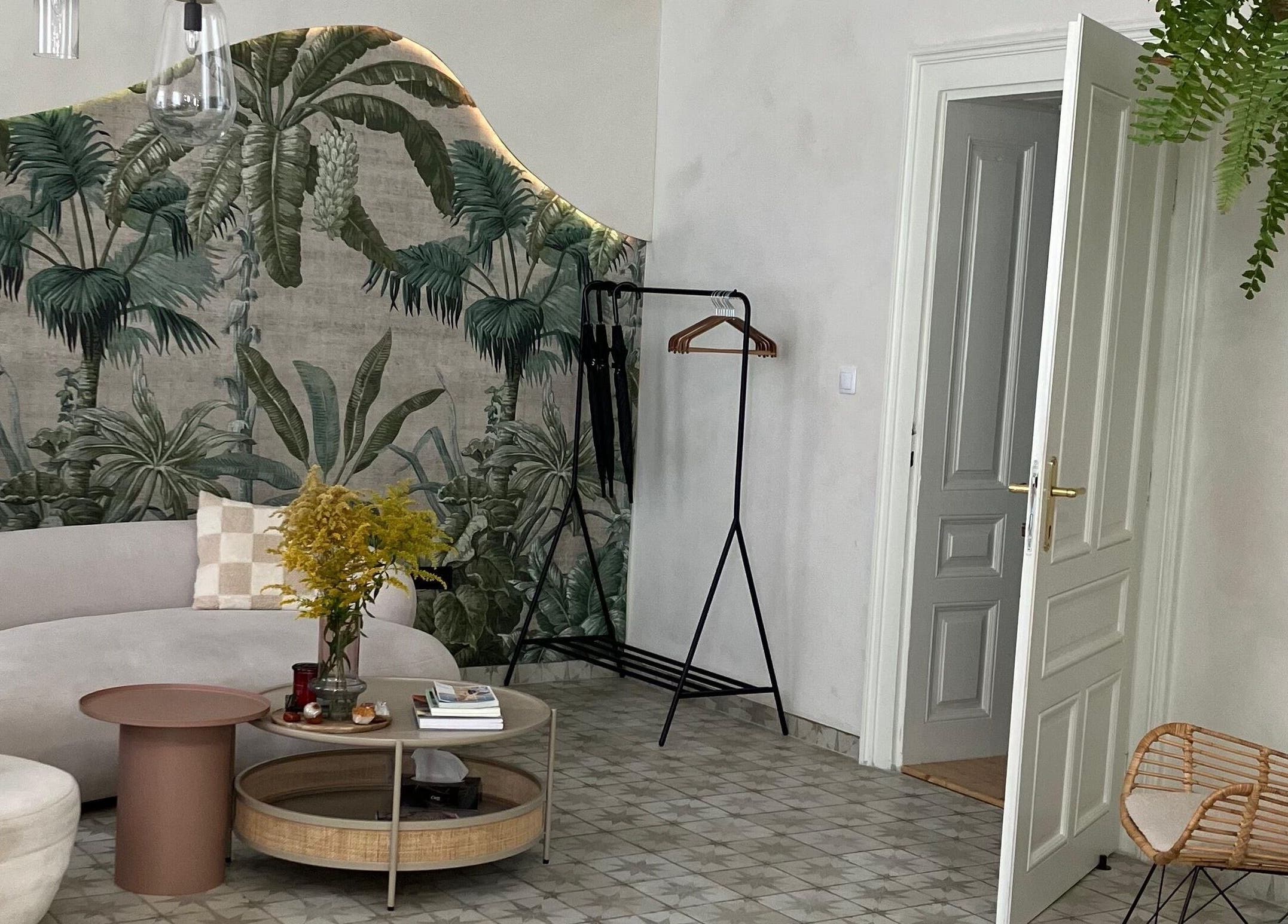 Stylový interiér Salon Veera v Ostravě, Moravskoslezský Kraj s tropickou tapetou a pohodlným nábytkem.