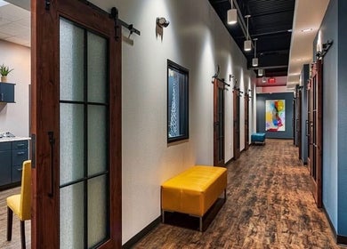 Stylish hallway at Serenity Aesthetics & Spa in Charlotte, North Carolina, US with modern decor and seating.