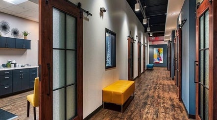 Stylish hallway at Serenity Aesthetics & Spa in Charlotte, North Carolina, US with modern decor and seating.