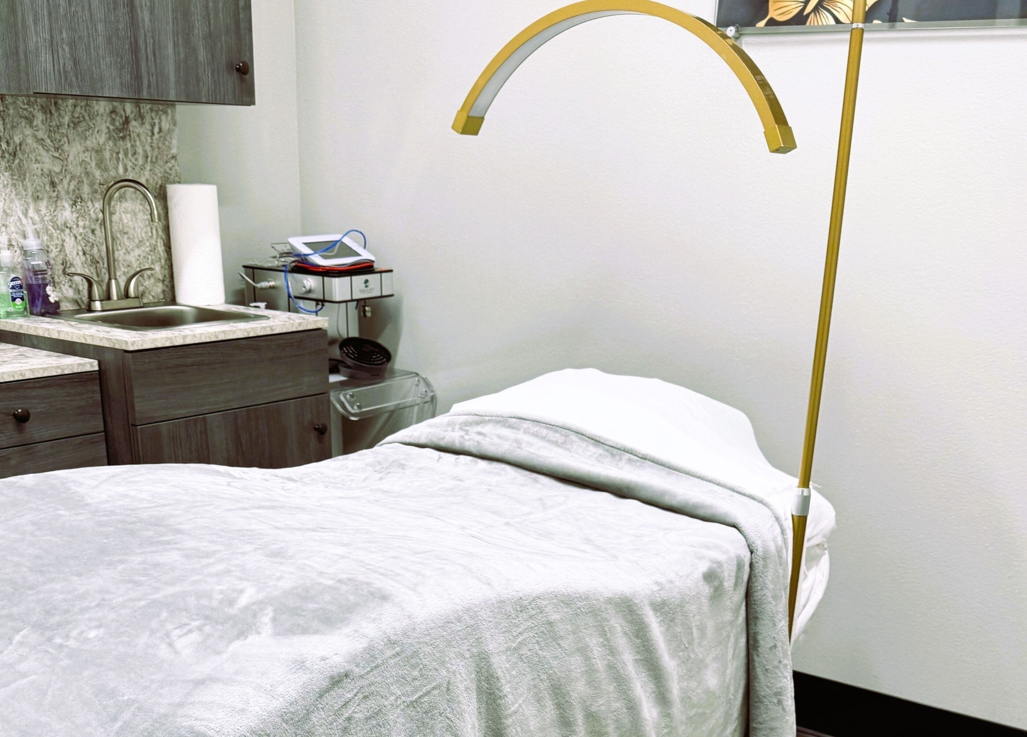 Serenity Aesthetics & Spa in Charlotte, North Carolina, US offers a tranquil treatment room with a comfortable bed.