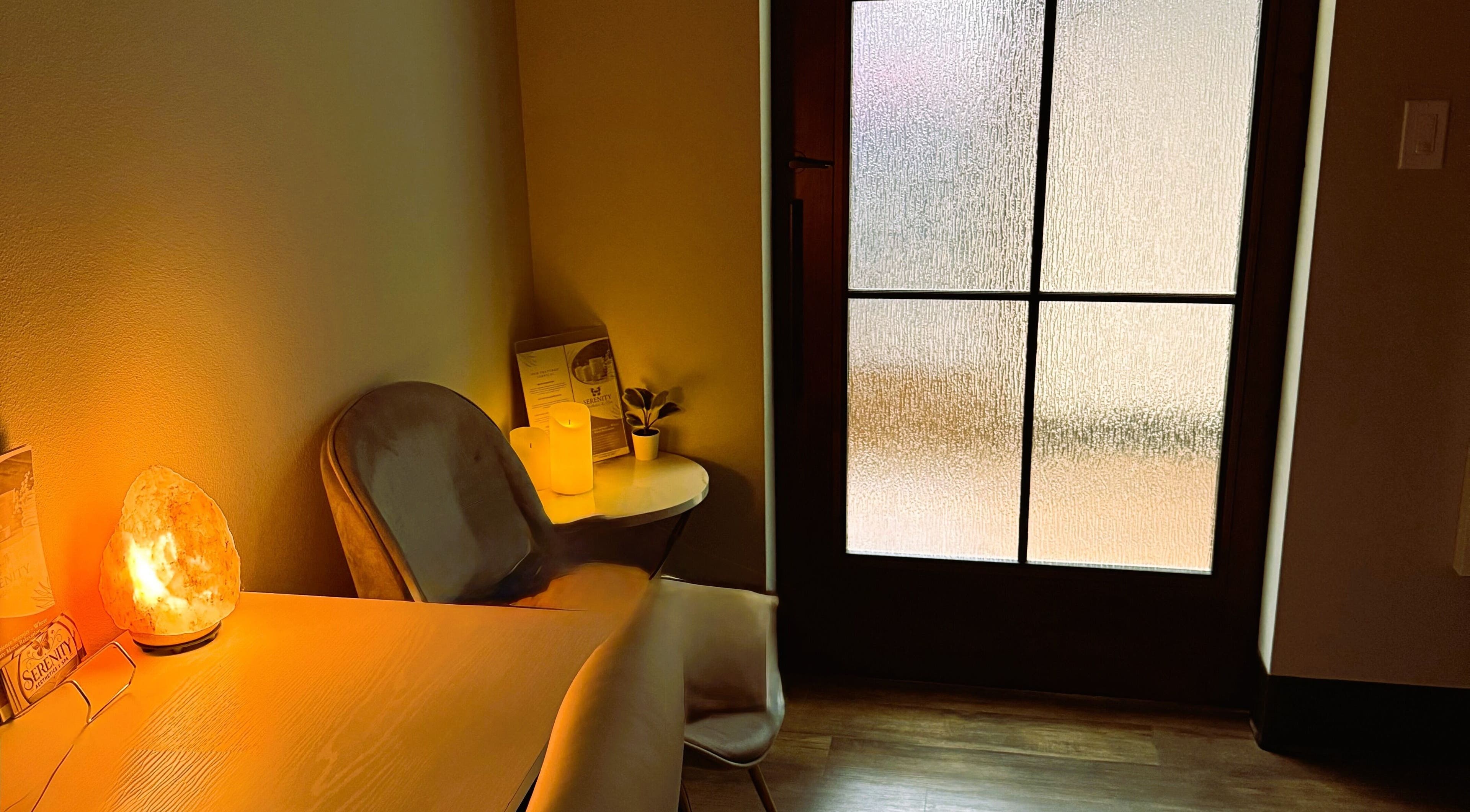 Warm, inviting spa corner at Serenity Aesthetics & Spa in Charlotte, North Carolina, US, with candles and salt lamp.