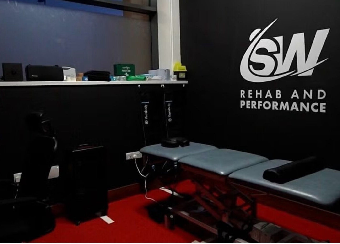 T.N Sport Therapy room in Llanelli, Wales, GB, showing a therapy bed and anatomy model.