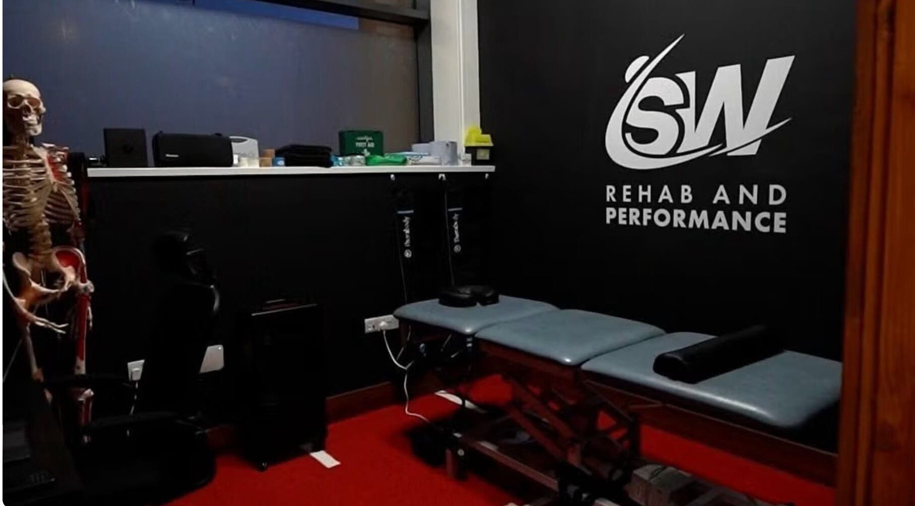 T.N Sport Therapy room in Llanelli, Wales, GB, showing a therapy bed and anatomy model.