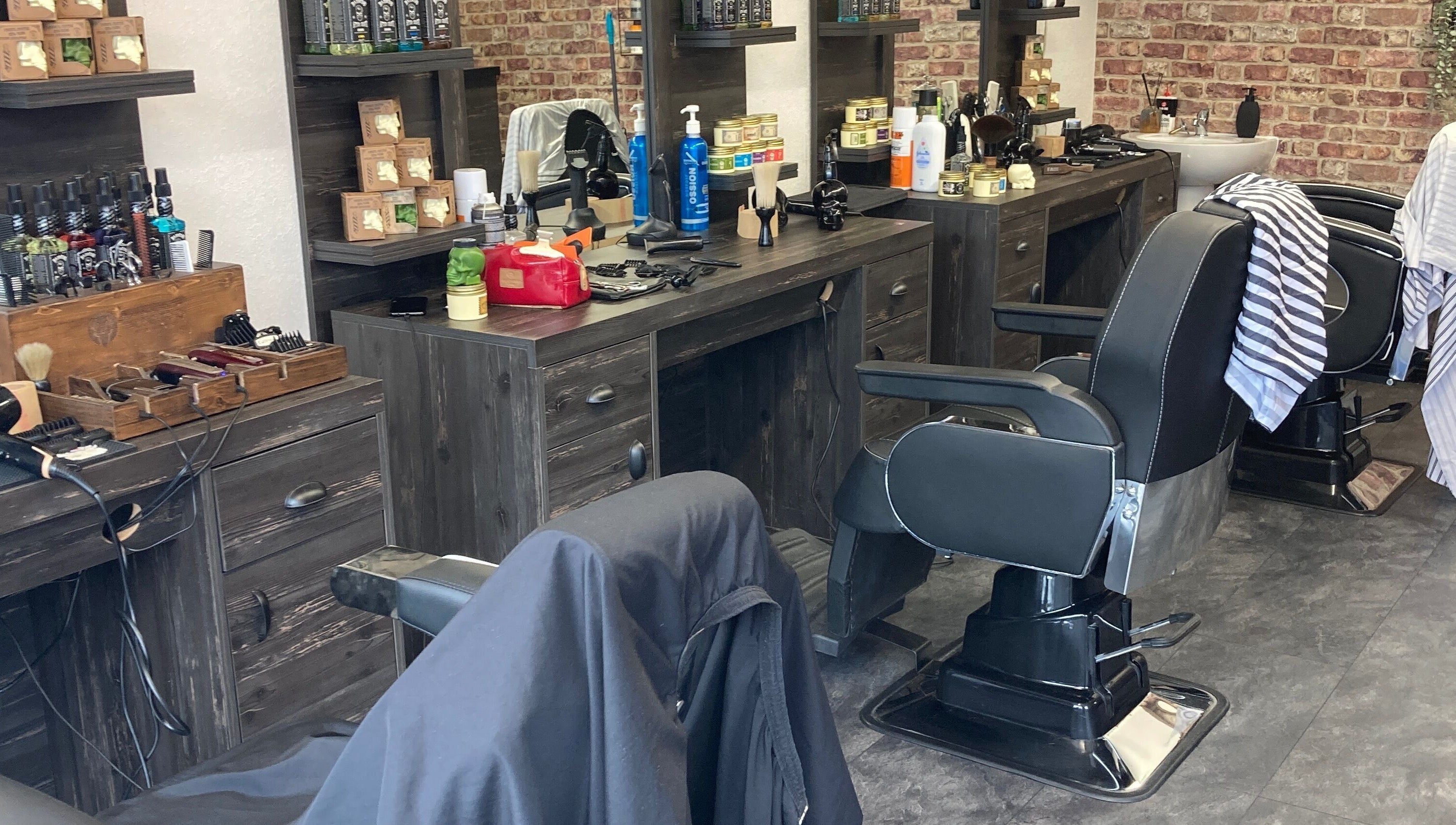 Modern barbershop interior at Cutcorner, County Kildare, IE showcasing sleek barber chairs and grooming products.
