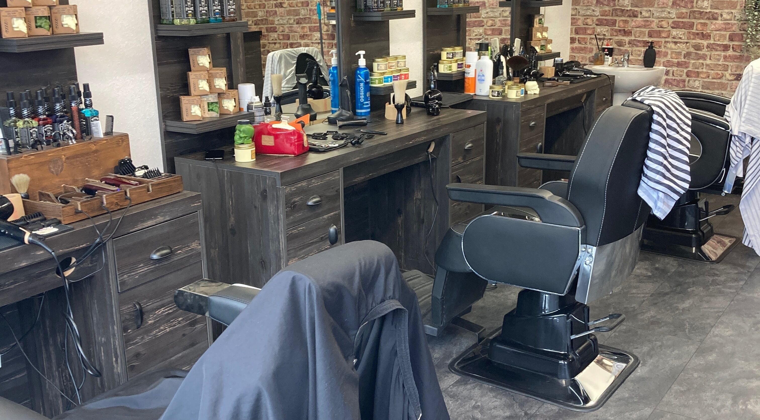 Modern barbershop interior at Cutcorner, County Kildare, IE showcasing sleek barber chairs and grooming products.