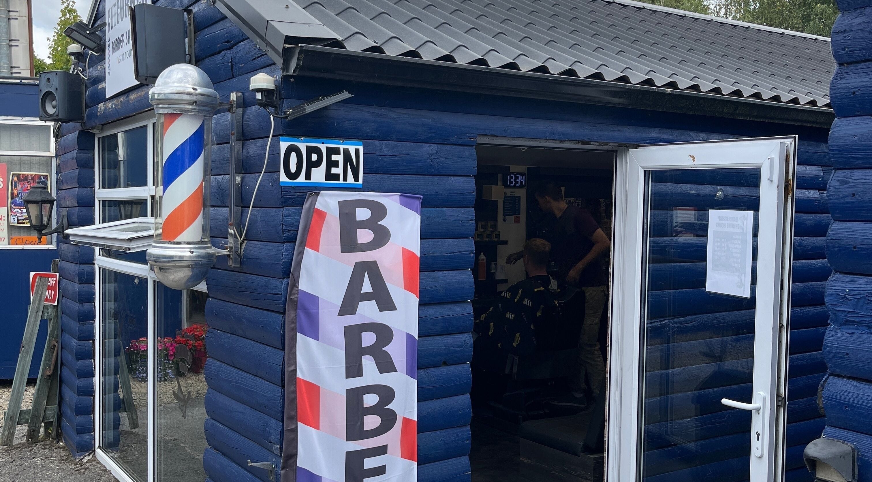 Exterior of Cutcorner barbershop with vibrant blue facade in County Kildare, County Kildare, IE.