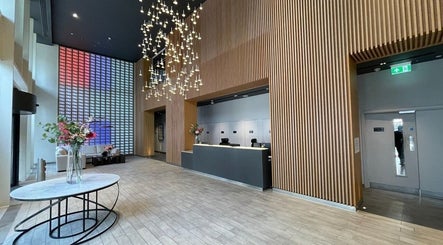 Modern lobby at JZ Nailed It, Croydon, England, GB with chic lighting and wood accents.
