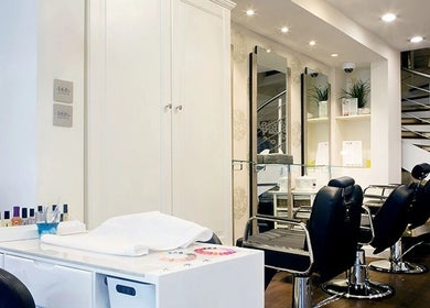 Modern salon interior at Anya Spa@Angel, London, England, GB featuring chic black chairs and a tidy nail station.