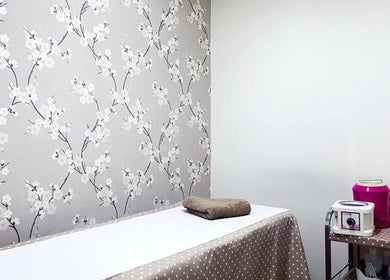 Tranquil massage room at Anya Spa@Angel, London, England, GB with floral decor and a relaxing ambiance.