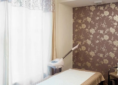 Treatment room at Anya Spa@Angel, London, England, GB, featuring floral walls and relaxing ambiance.