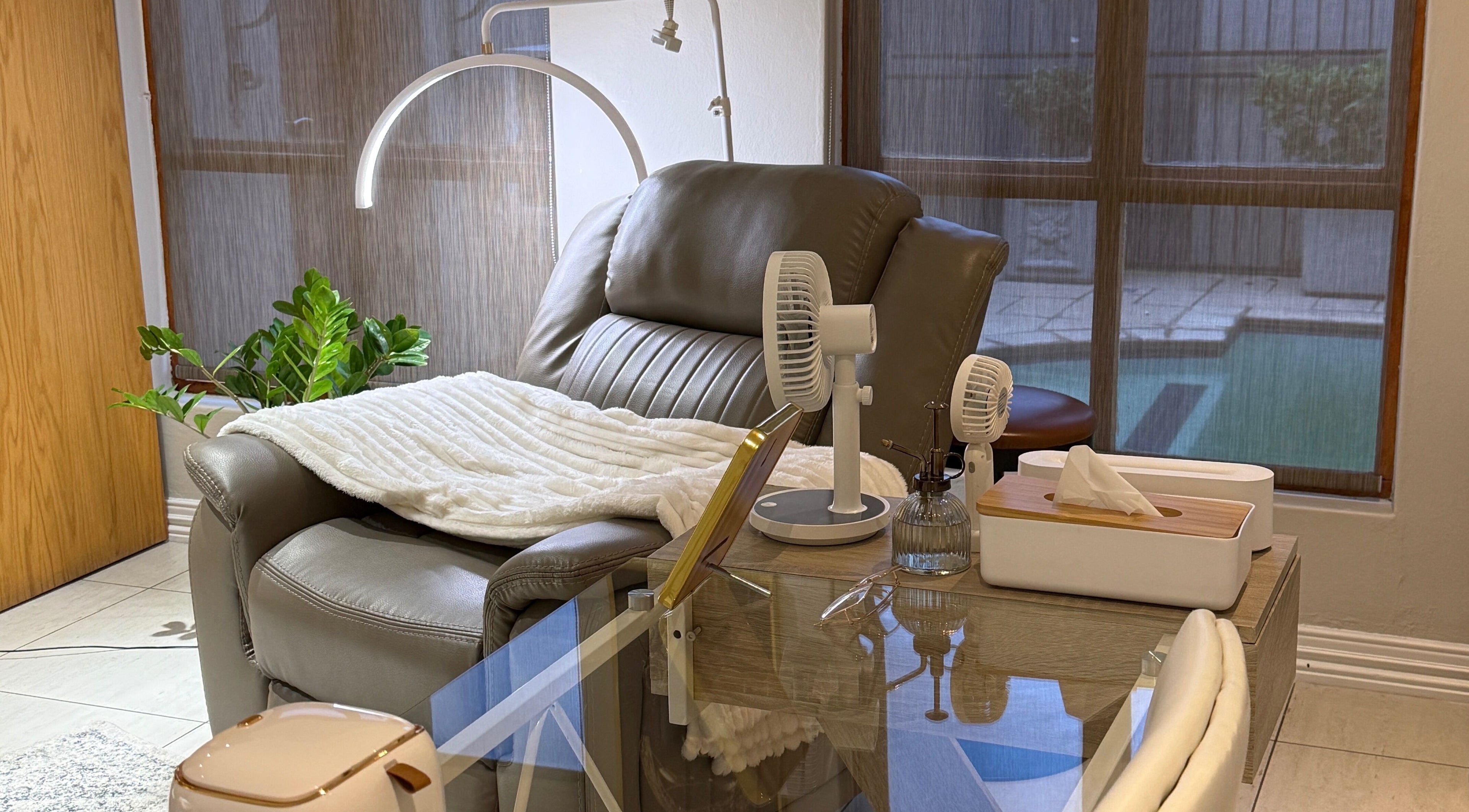 Cozy massage chair at Melanin Aesthetics SA, Germiston, Gauteng, ZA with blanket and fan setup.