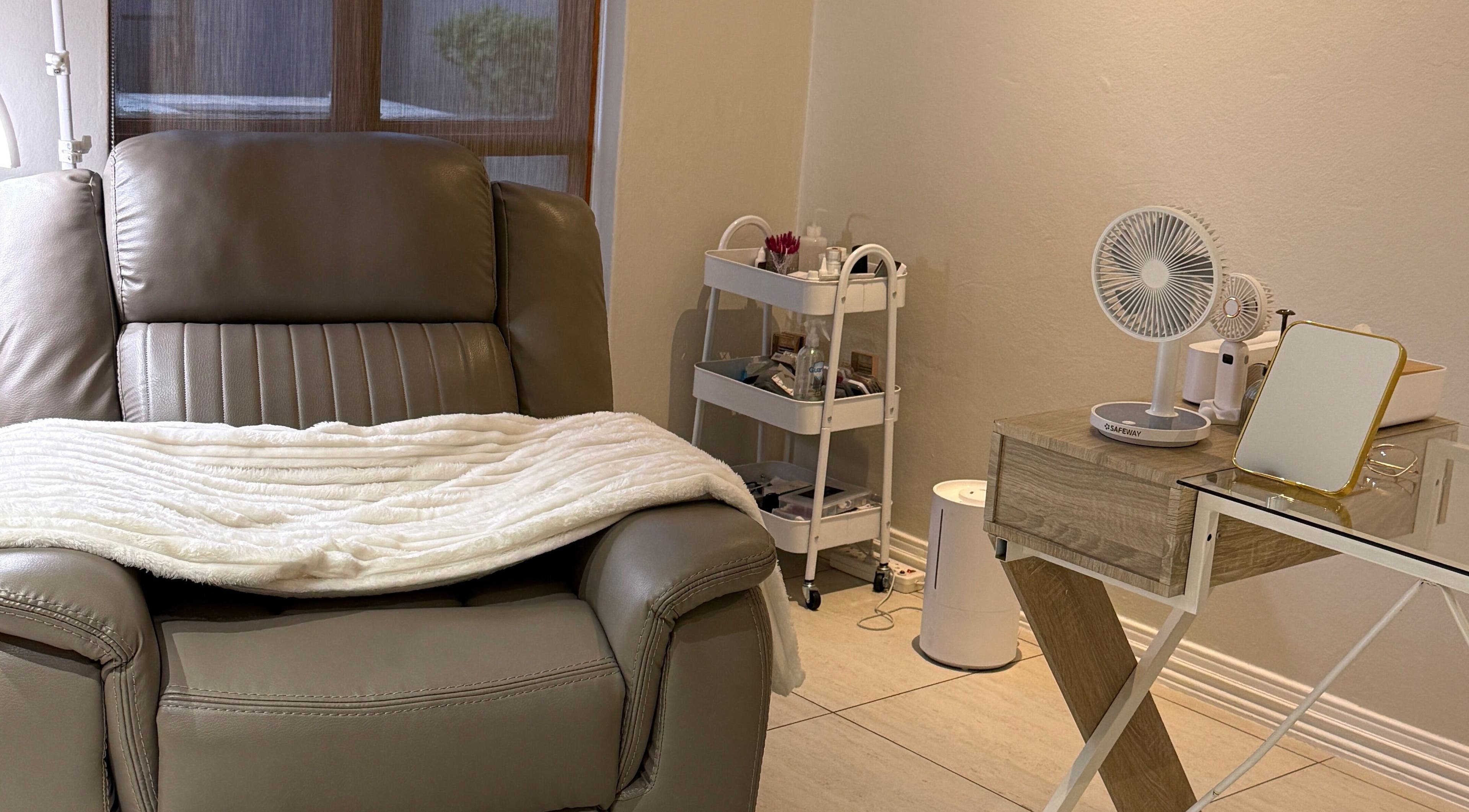 Relaxing leather chair setup at Melanin Aesthetics SA, Germiston, Gauteng, ZA with side table and beauty essentials.