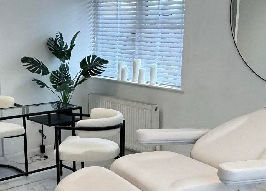 Sculpted By SL's serene treatment room with white furnishings in Ashford, England, GB.