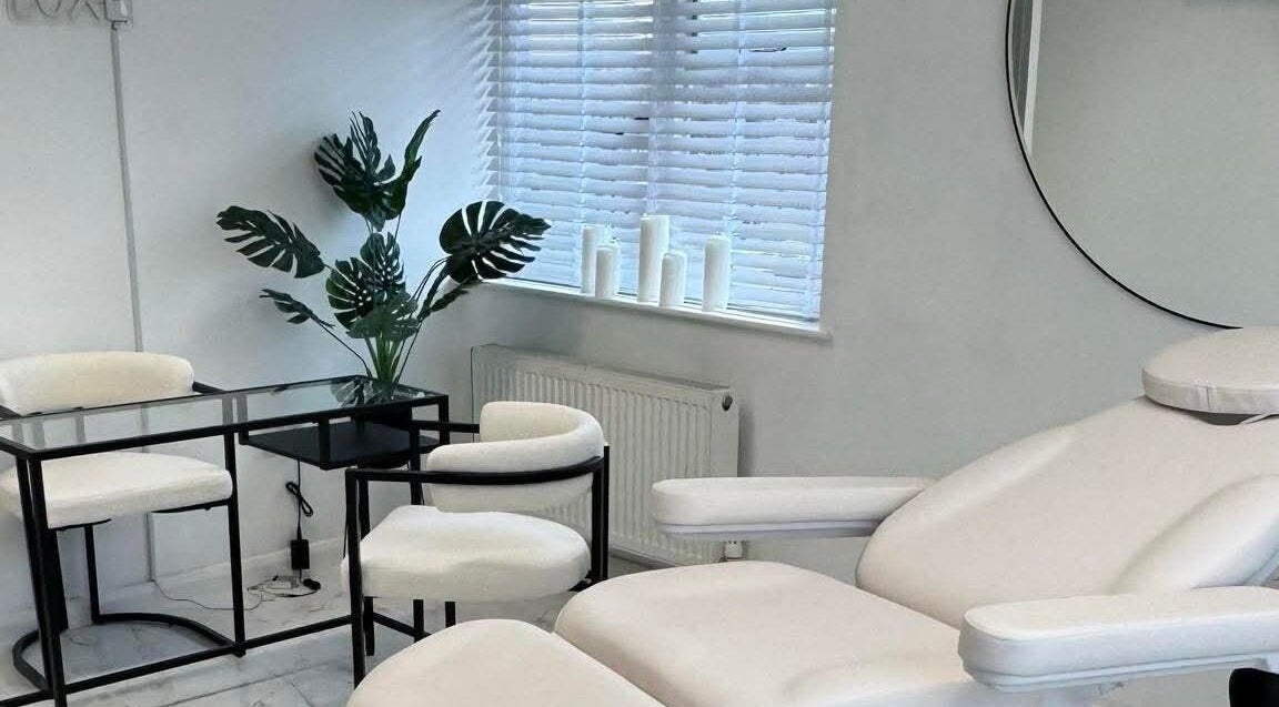 Sculpted By SL's serene treatment room with white furnishings in Ashford, England, GB.