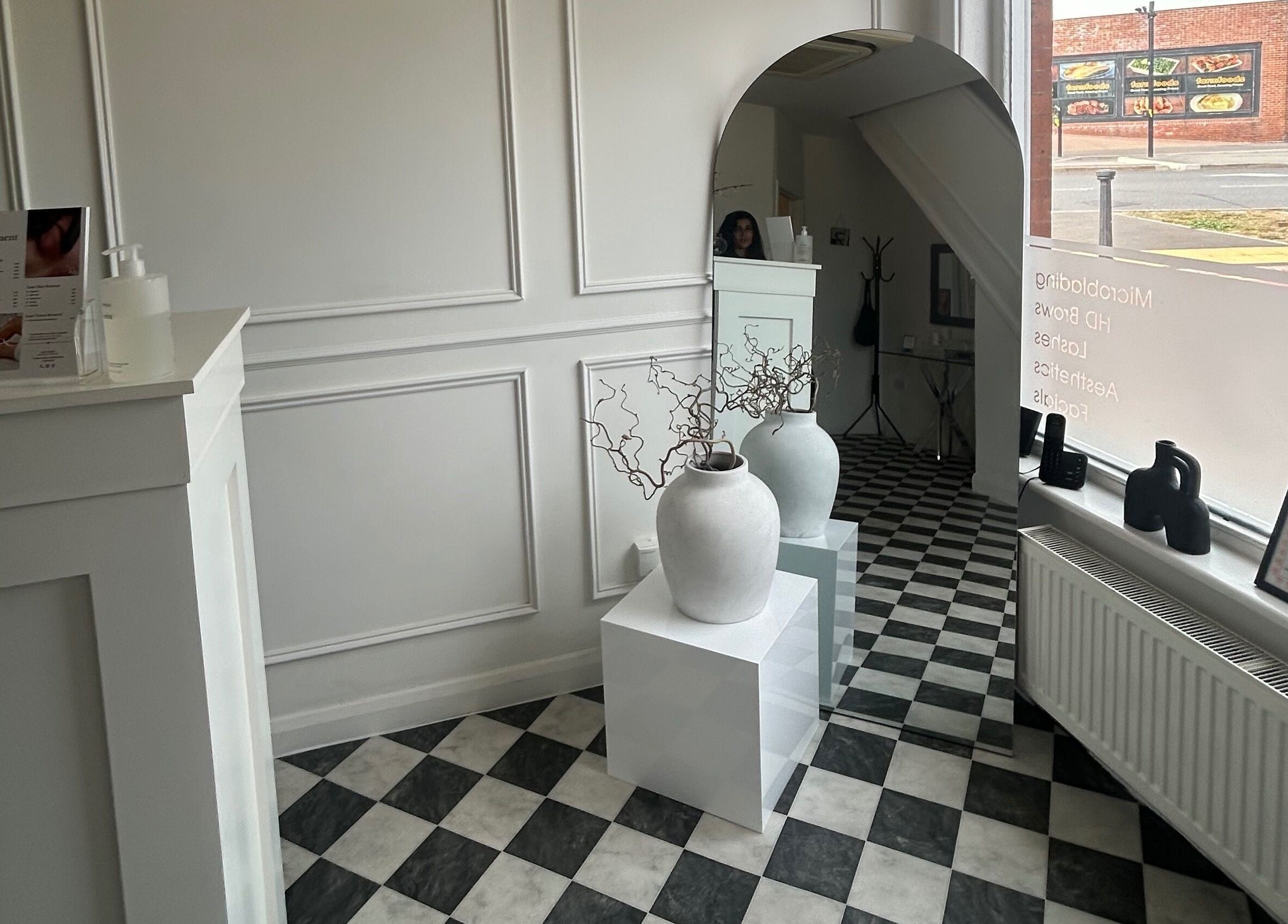 Minimalistic reception area at Sculpted By SL in Ashford, England, GB with modern decor and natural light.