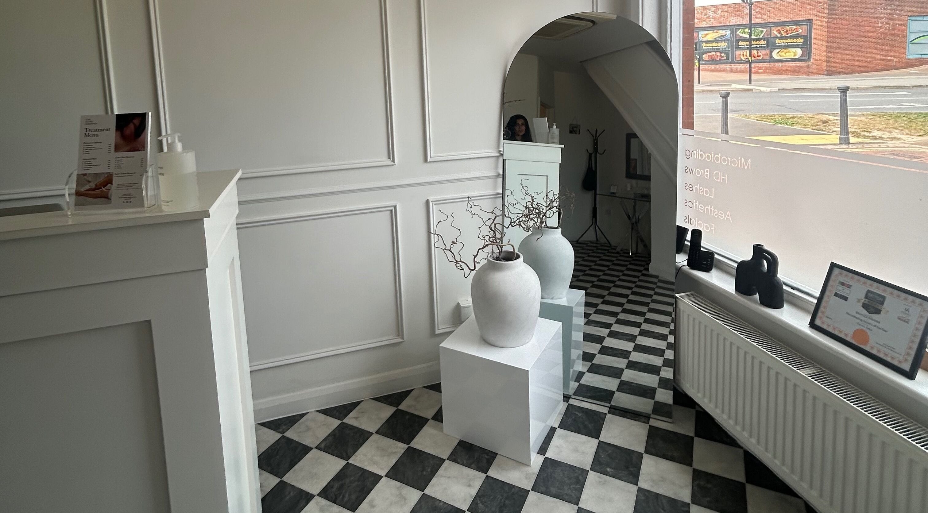 Minimalistic reception area at Sculpted By SL in Ashford, England, GB with modern decor and natural light.