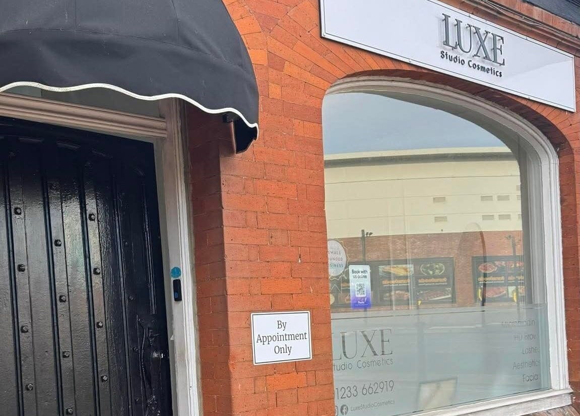 Exterior view of Sculpted By SL at Ashford, England, GB with brick wall and by-appointment sign.