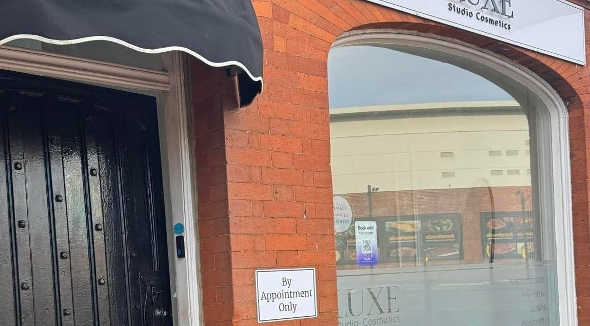 Exterior view of Sculpted By SL at Ashford, England, GB with brick wall and by-appointment sign.