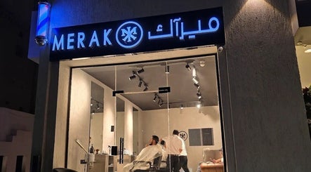 Night view of MERAK BARBERSHOP in Jeddah, Makkah Province, SA, showcasing its bright signage and modern interior.