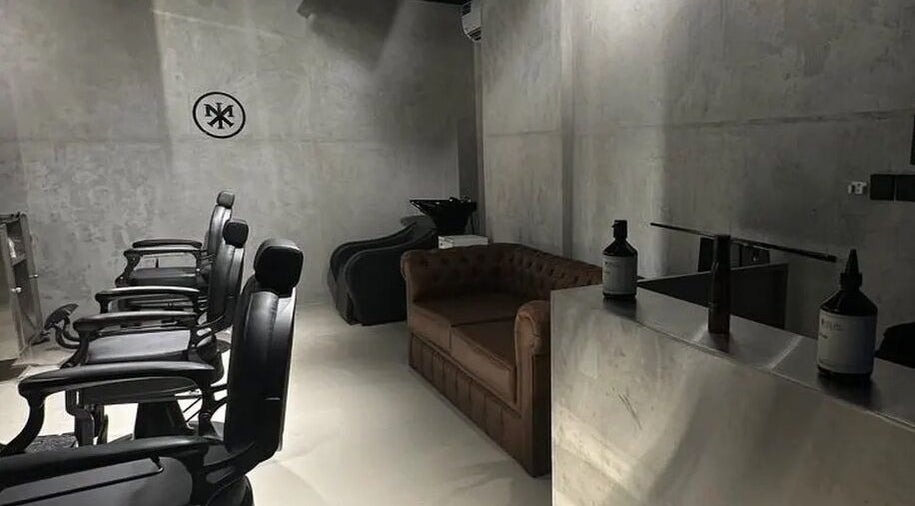 Interior of Merak Barbershop, Jeddah, Makkah Province, SA with stylish chairs and modern decor.