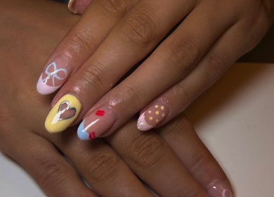 Unique nail art at Nails By Katie, Coleraine, Northern Ireland, GB. Pastel designs with heart and bow accents.