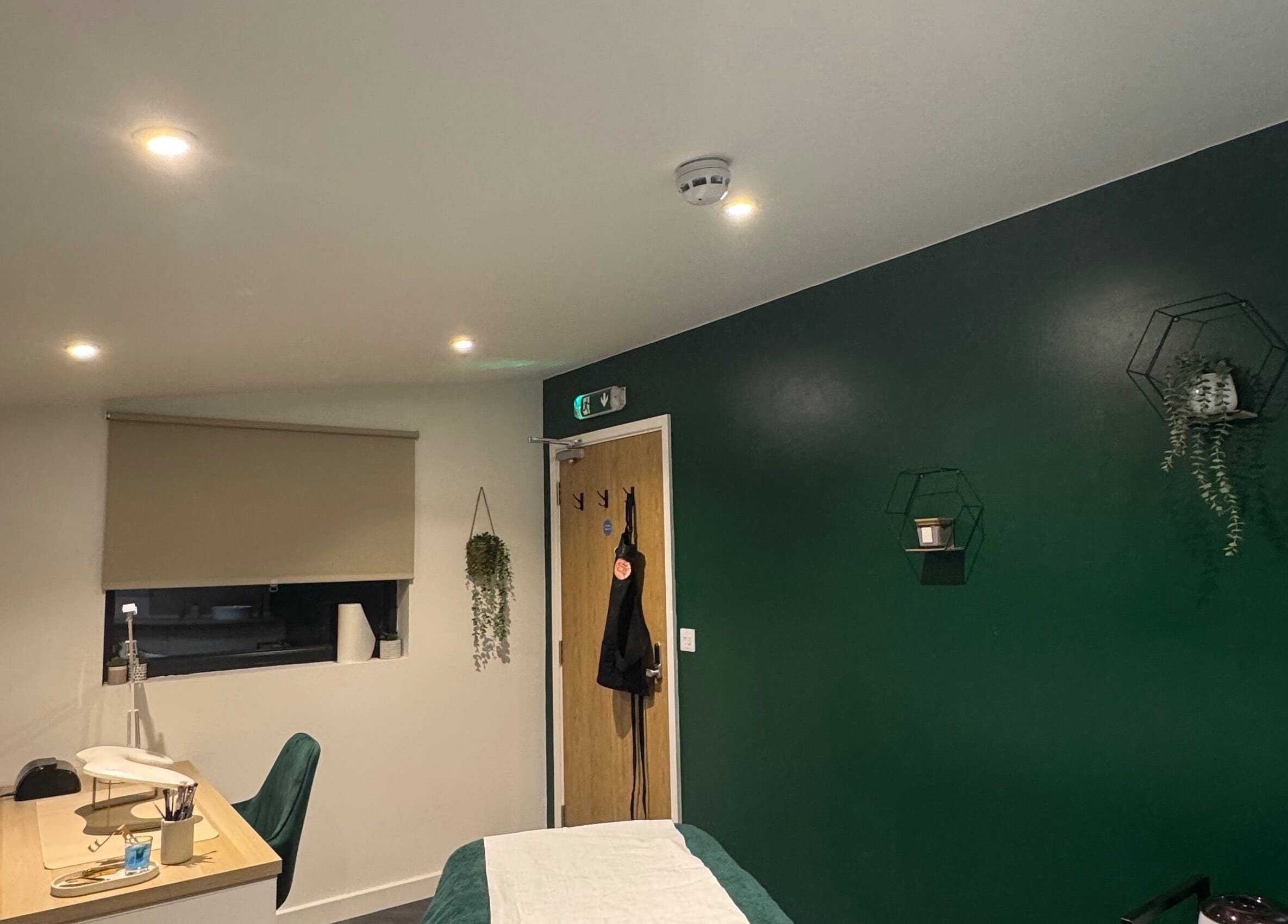 Calm and modern treatment room at SH Enhancements, Somerton, England, GB, featuring elegant decor.