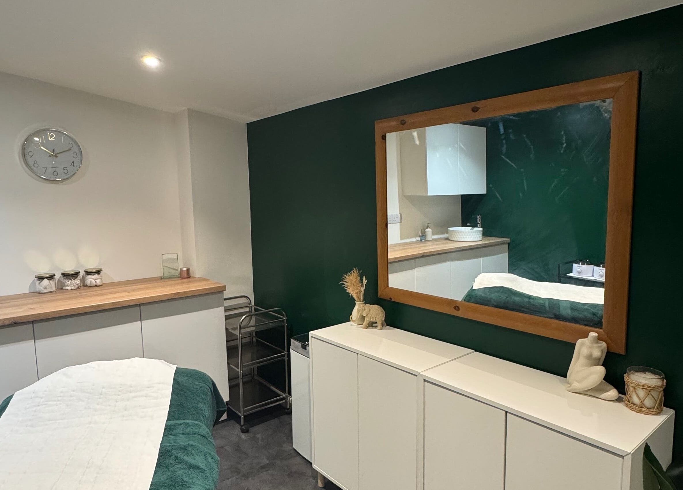 Calm therapy room at SH Enhancements, Somerton, England, GB, featuring a treatment table and decor.