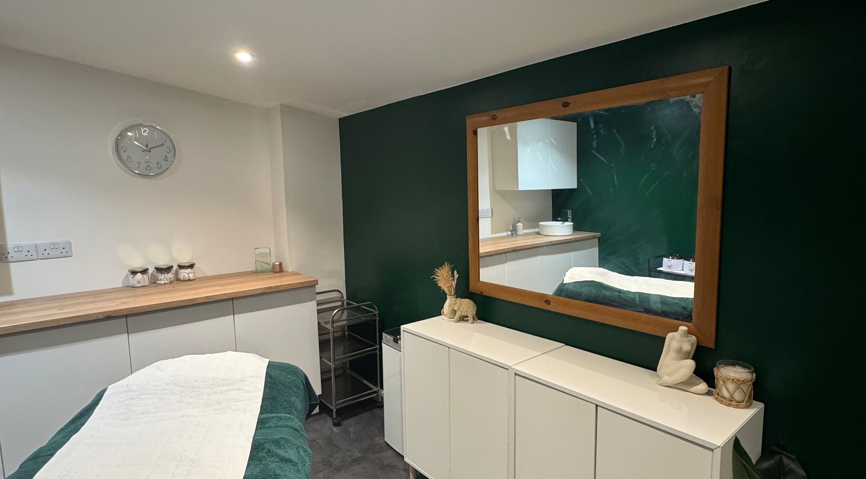 Calm therapy room at SH Enhancements, Somerton, England, GB, featuring a treatment table and decor.