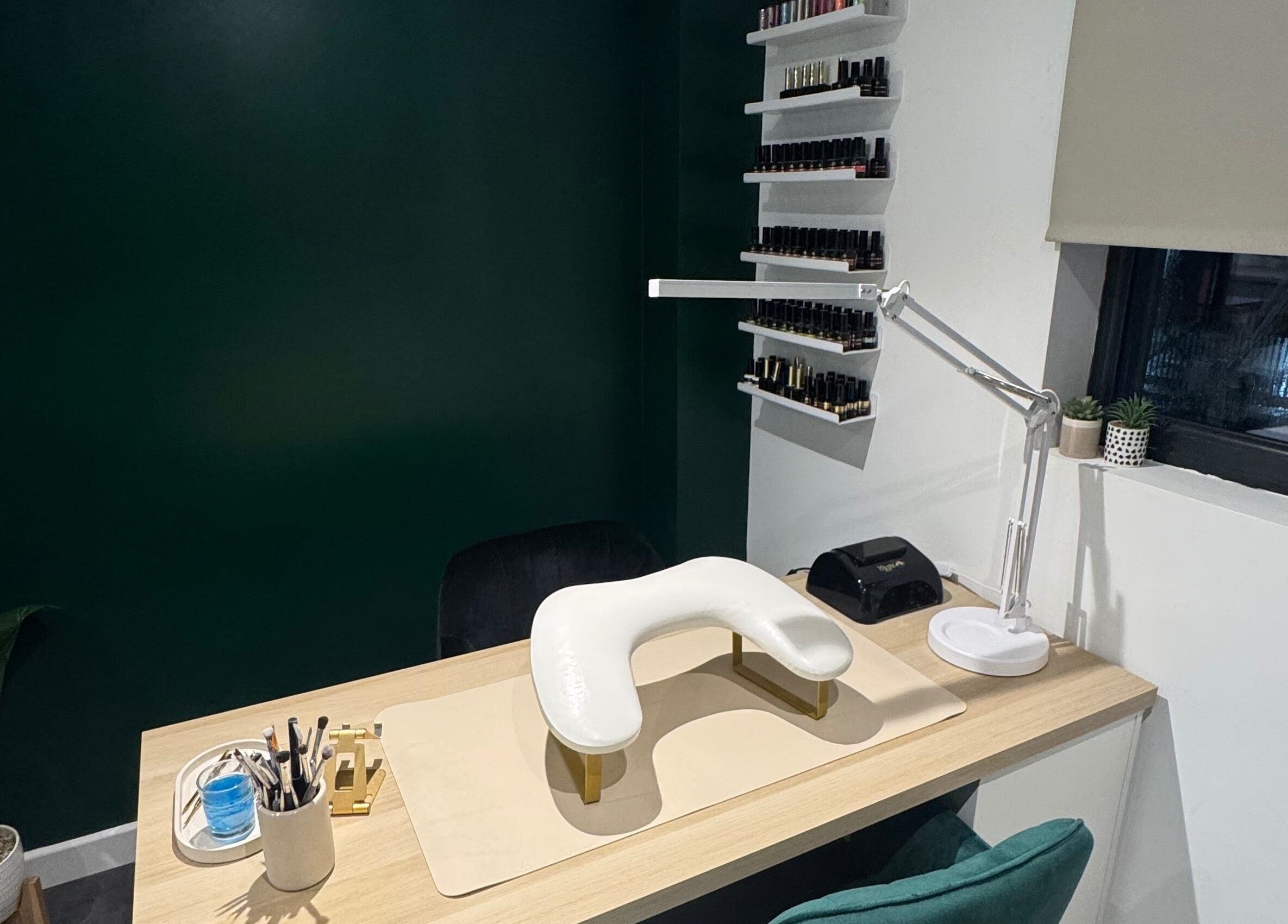 Elegant nail station at SH Enhancements, Somerton, England, GB with organized polish display and modern decor.