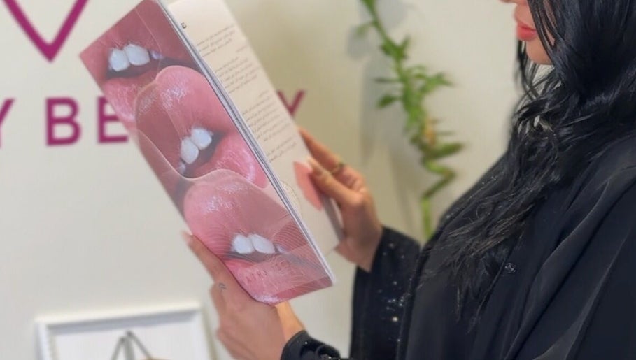 Client reading beauty booklet at Honey Beauty, Jeddah, Makkah Province, SA.