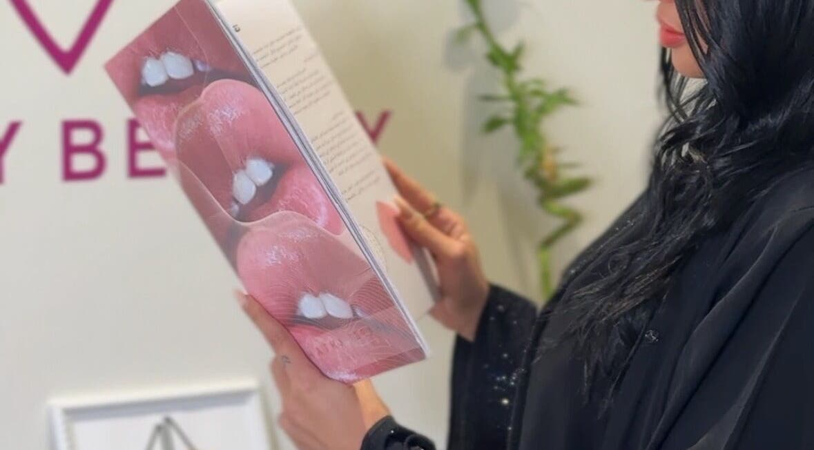 Client reading beauty booklet at Honey Beauty, Jeddah, Makkah Province, SA.