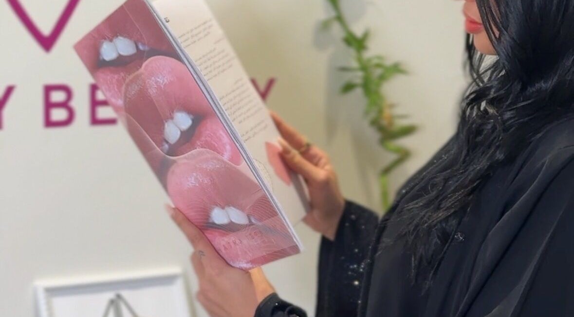 Client reading beauty booklet at Honey Beauty, Jeddah, Makkah Province, SA.