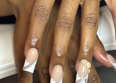 Delicate nail art by Nails_bylauryn in Bedford, England, GB featuring heart designs and floral accents.
