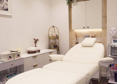 Luxury treatment room at SkinWell Aesthetics Boutique, London, England, GB with spa bed and skincare equipment.