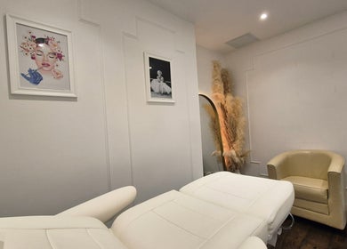 Cozy treatment room at SkinWell Aesthetics Boutique, London, England, GB, featuring elegant decor and plush seating.