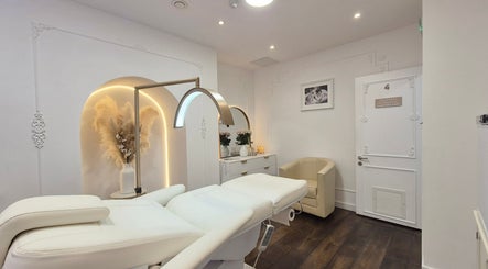 Luxurious treatment room at Skin Well Aesthetics Boutique, London, England, GB with plush decor and ambient lighting.